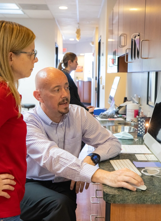 Dr. Daniel L. W. Fishel consulting with patients at F&S Orthodontics & Periodontics